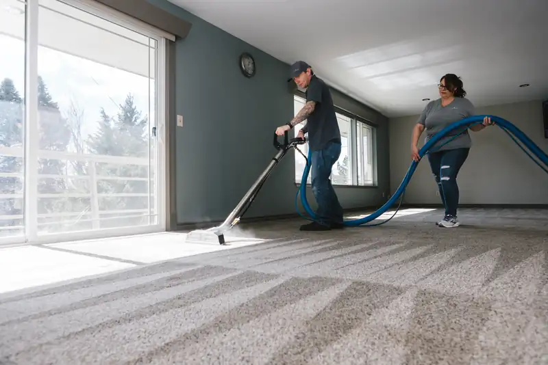 James and Renee cleaning carpet in a bright living room