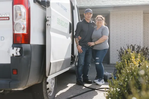 James and Renee Hughes standing beside the Raindrop Cleaning van